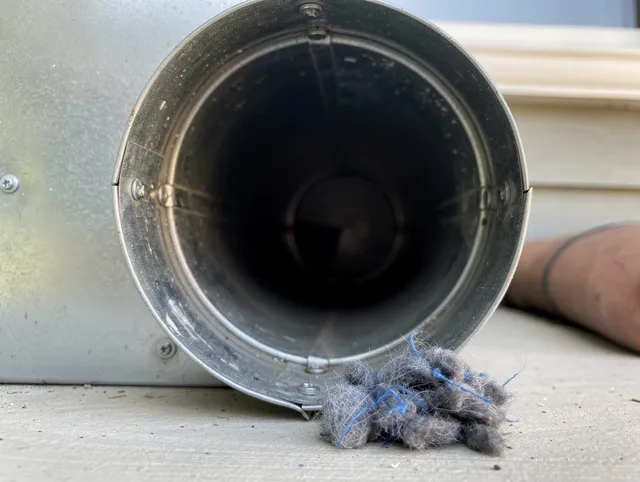 Lakeland Village Dryer Vent Cleaning technician using specialized equipment to clear severe dryer vent blockage in Lakeland Village